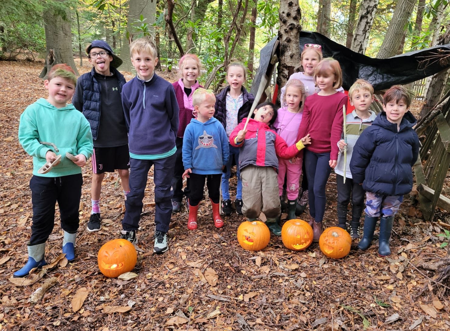Group of children with 4 pumpkins