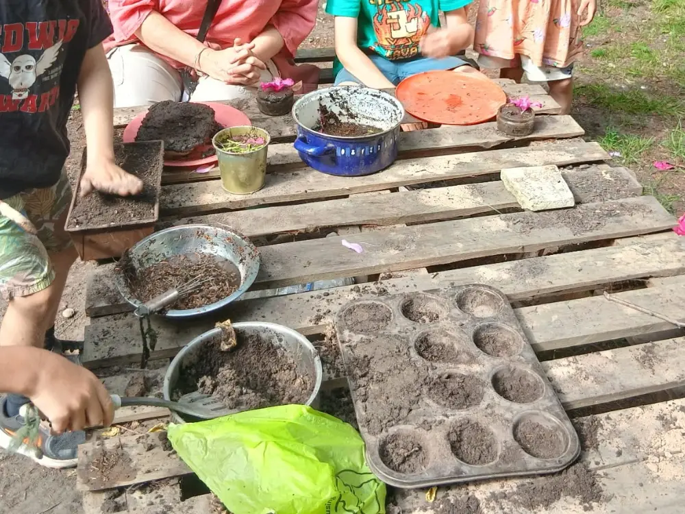 Pots, pans and muddy creations on the mud kitchen table
